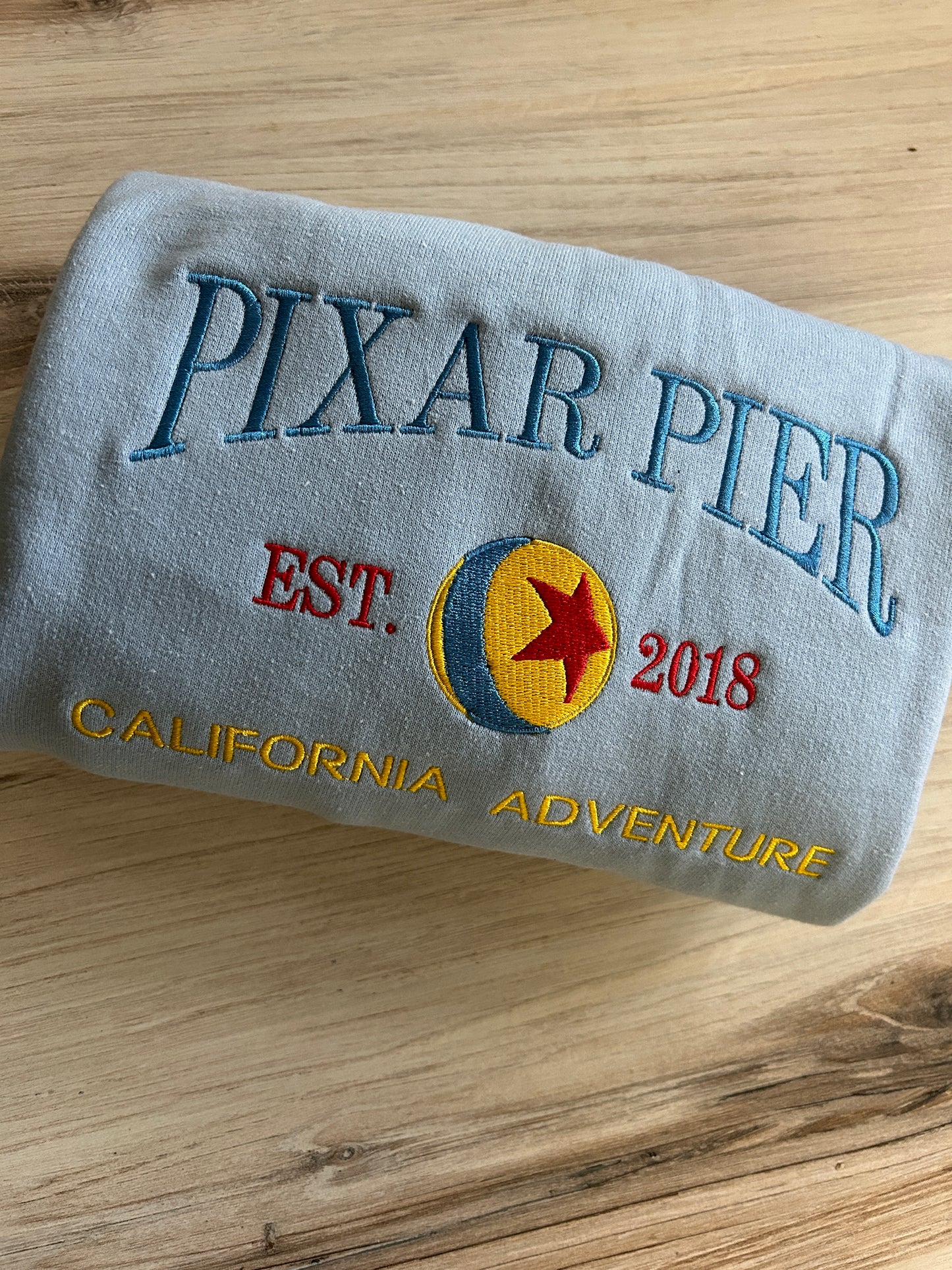 Pixar Pier Embroidered Sweater